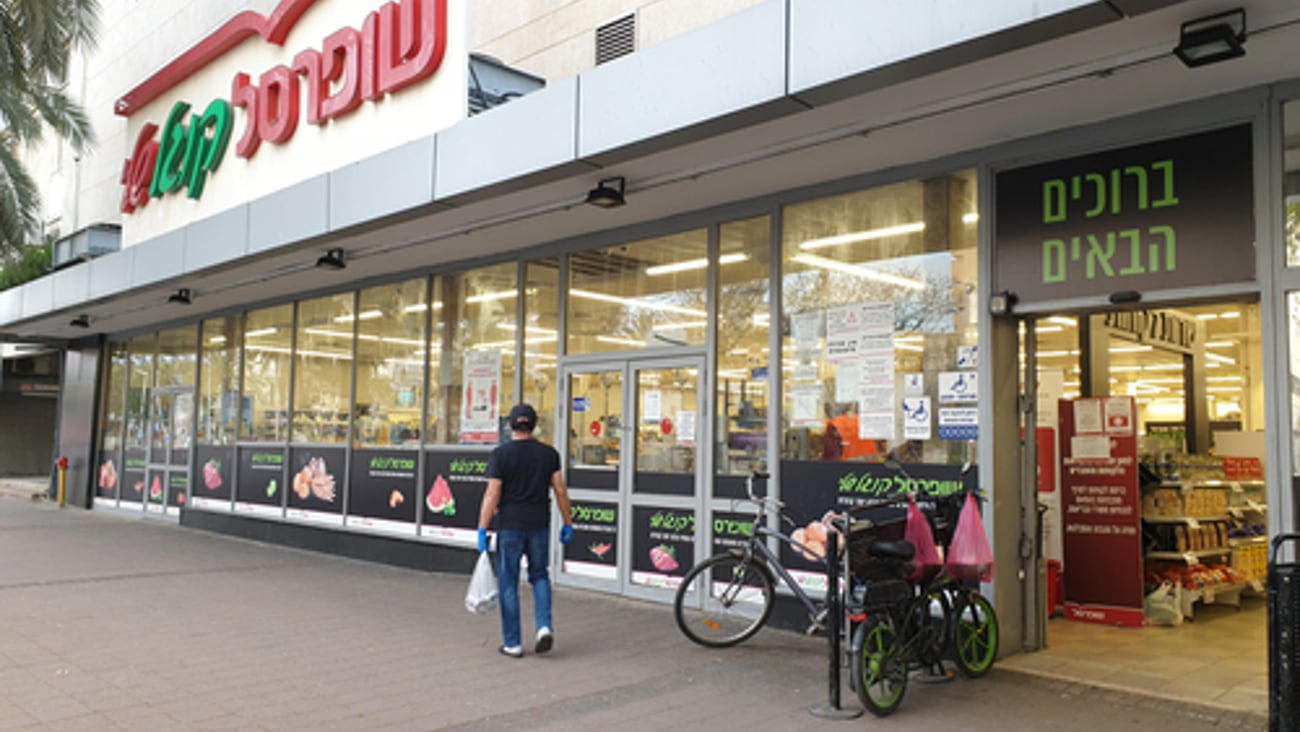 a group of people walking in front of a store