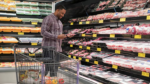 man shopping in meat section