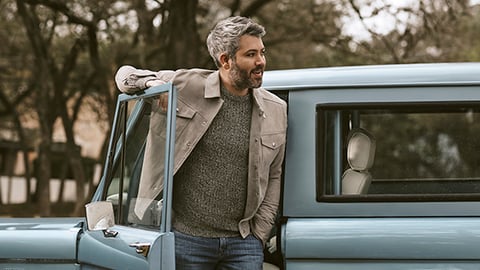 a man standing next to a car