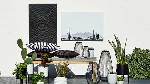 a room filled with furniture and vase of flowers on a table