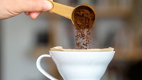 a close up of a person holding a cup of coffee