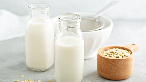 a glass of milk next to a cup of coffee