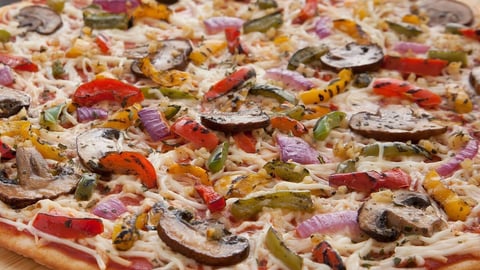 a pizza sitting on top of a wooden table