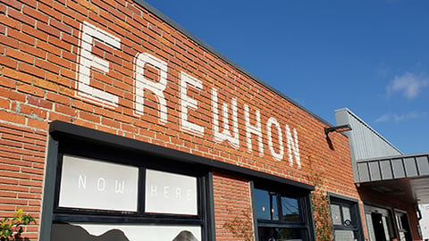 a sign in front of a brick building