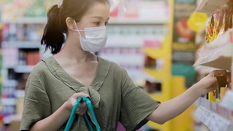 a woman standing in front of a store