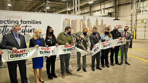 a group of people standing in front of a crowd posing for the camera