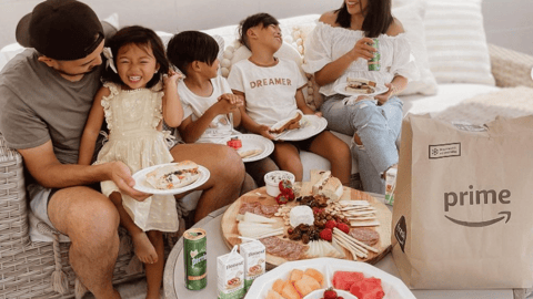 a group of people sitting at a table with a plate of food