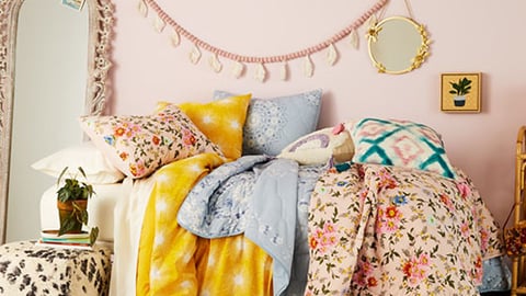 a bed with pillows and blankets