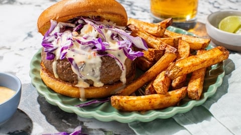 Home Chef Bang Bang Beef Burger with seasoned fries and lime.