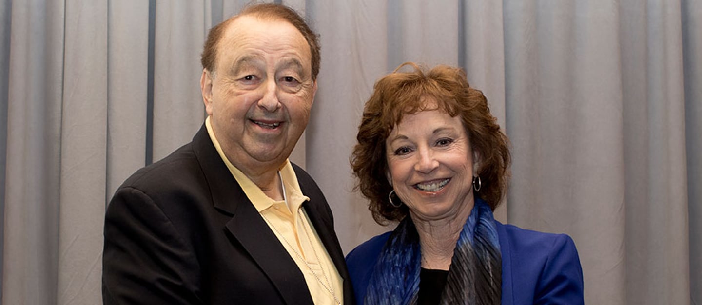 a man and a woman posing for the camera