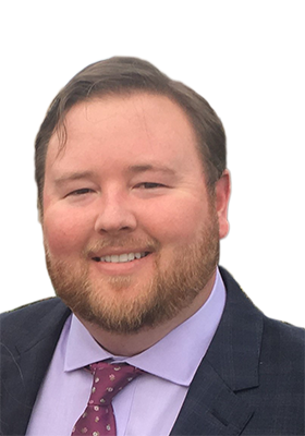 a man wearing a suit and tie smiling at the camera