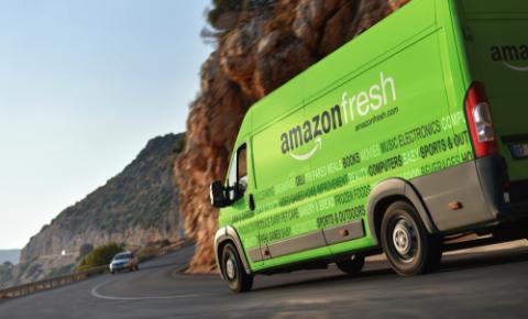 a green truck is driving down the road
