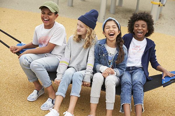 a group of people sitting on a bench posing for the camera