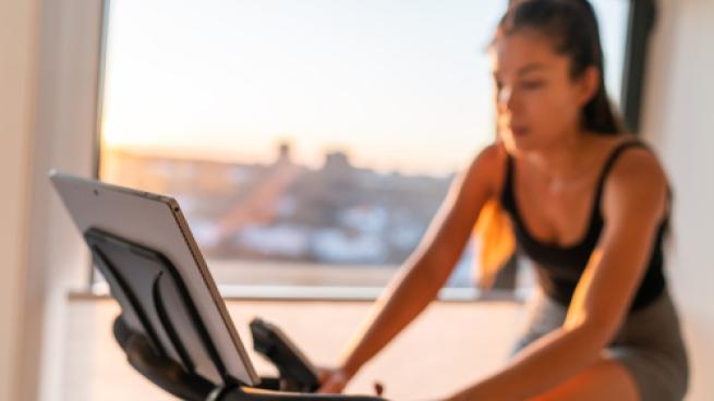 a woman standing in front of a laptop